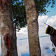 A Dessana indigenous man plays with a baby by the Negro River at the Tupe Reservation in the outskirts of Manaus, Amazonas, Brazil.